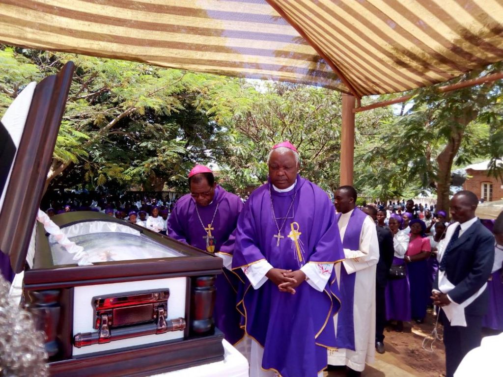 Picture of Bishop Mtumbuka (in front) and Archbishop Ziyaye (behind) file past the body of Bishop Kanyama
