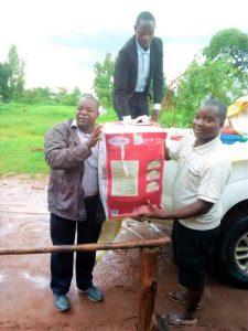 Picture of Fr Bulambo (left) presenting some of the gifts to Fr Petros Mwale