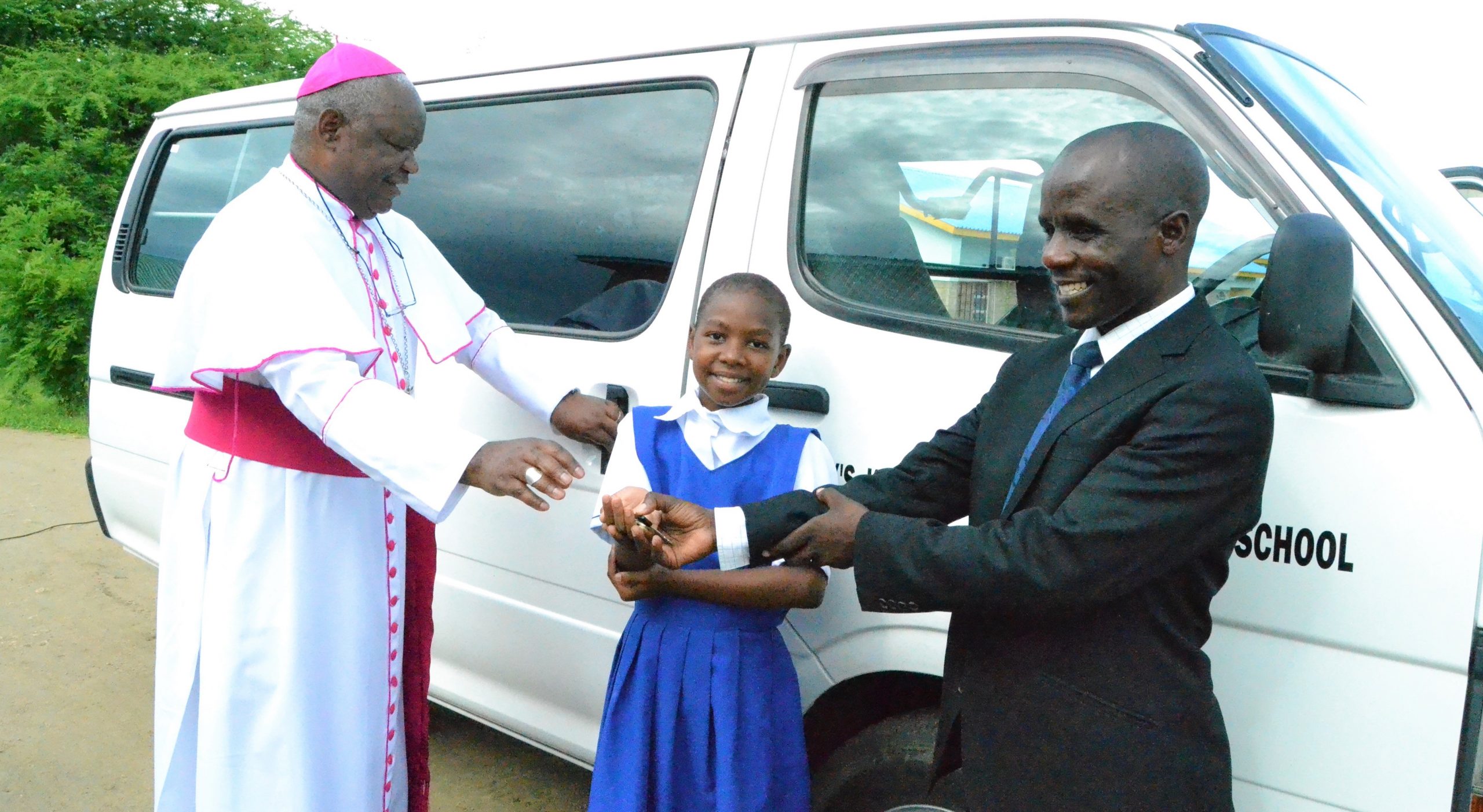 Picture of Bishop Mtumbuka hands over keys to the Mr Ngwira and a student representative