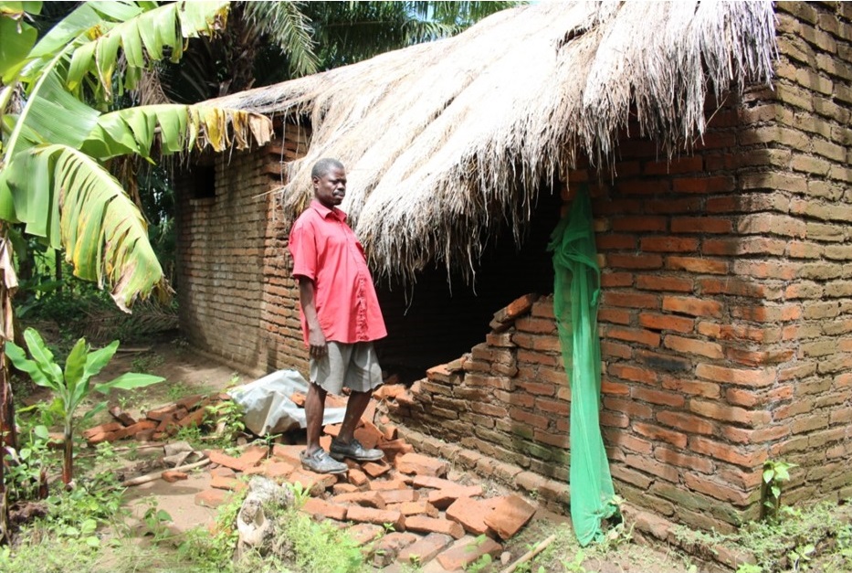 Picture of Figure 3: A flood victim in Mangulu Village whose house is damaged