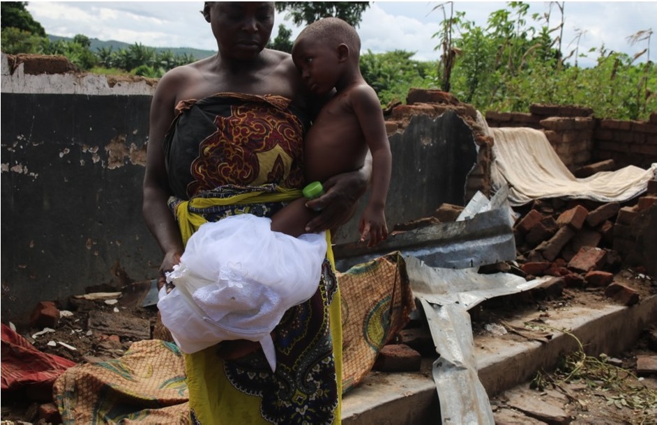 Picture of Figure 1: Showing a woman under Elias village in GVH Katumbi whose house is completely razed down