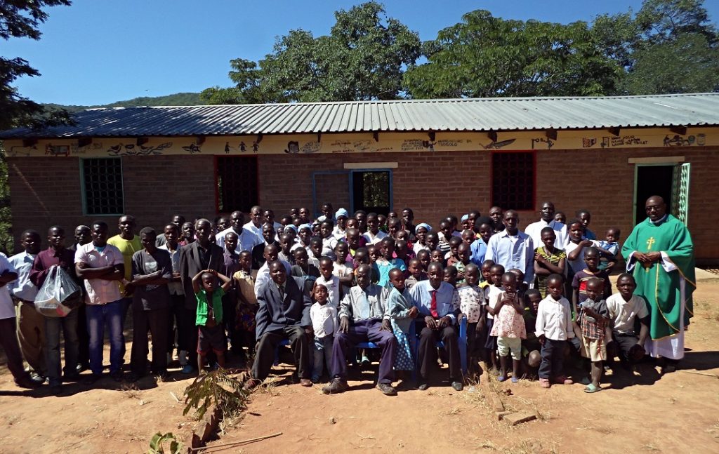 Mons. Denis Chitete has a group photo with the congregation after Mass at Juma