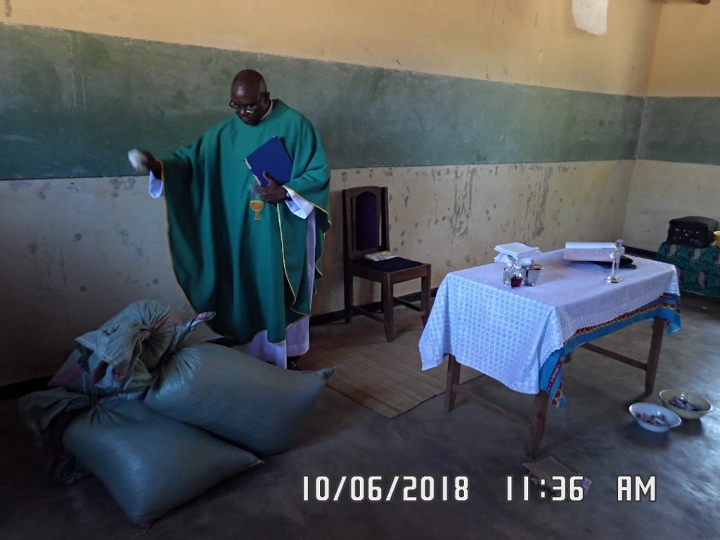The Vicar General blesses part of the harvest offering to the Church by the Juma Catholics