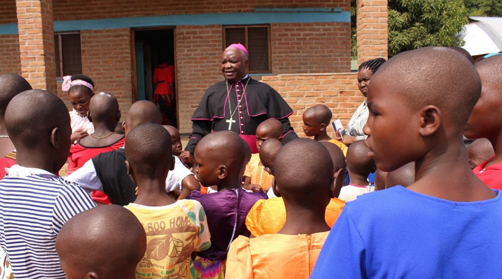 Bishop Mtumbuka interacts with children under the Lusubilo Orphan Care 