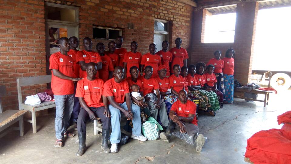 Community TB Volunteers putting on t-shirts as part of their identity 