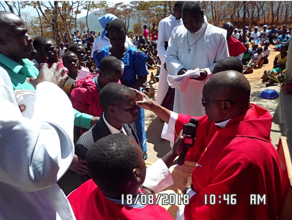 Monsignor Chitete administering the Sacrament of Confirmation