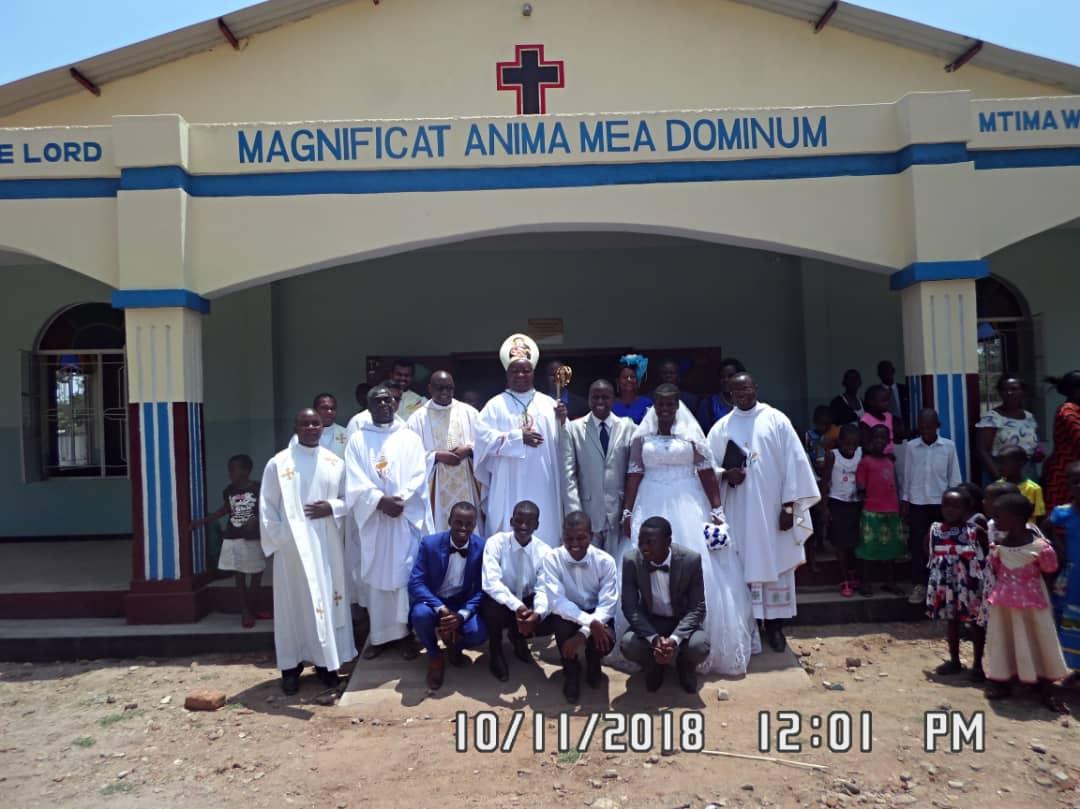 Bishop Mtumbuka flanked by the Vicar General, the Nyondo Family and other priests after the opening Masswith the Nyondo Family and pr