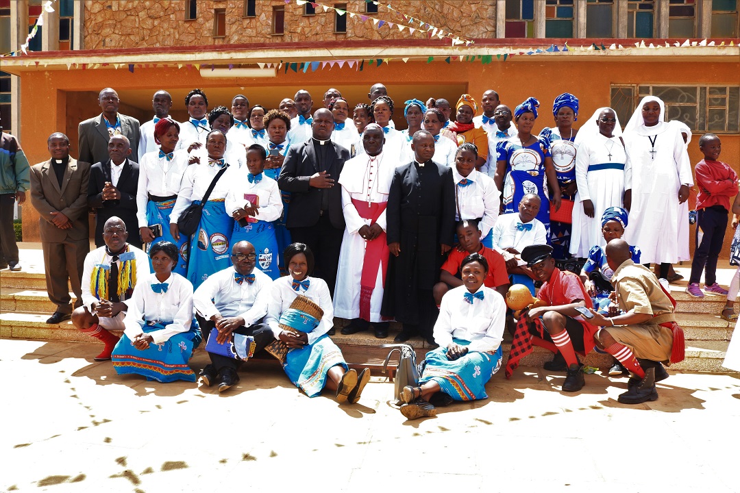 Members of Tuntufye Choir pose for a photo with Bishop Maluma