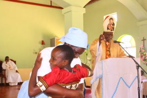 Caroline Banda being welcomed by the Headmistress of St Mary's Girls Mrs Martha Nyondo