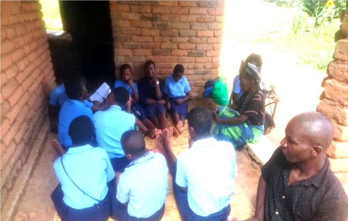 Girls chatting with one of the elderly women