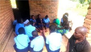 g8 Girls chatting with one of the elderly women