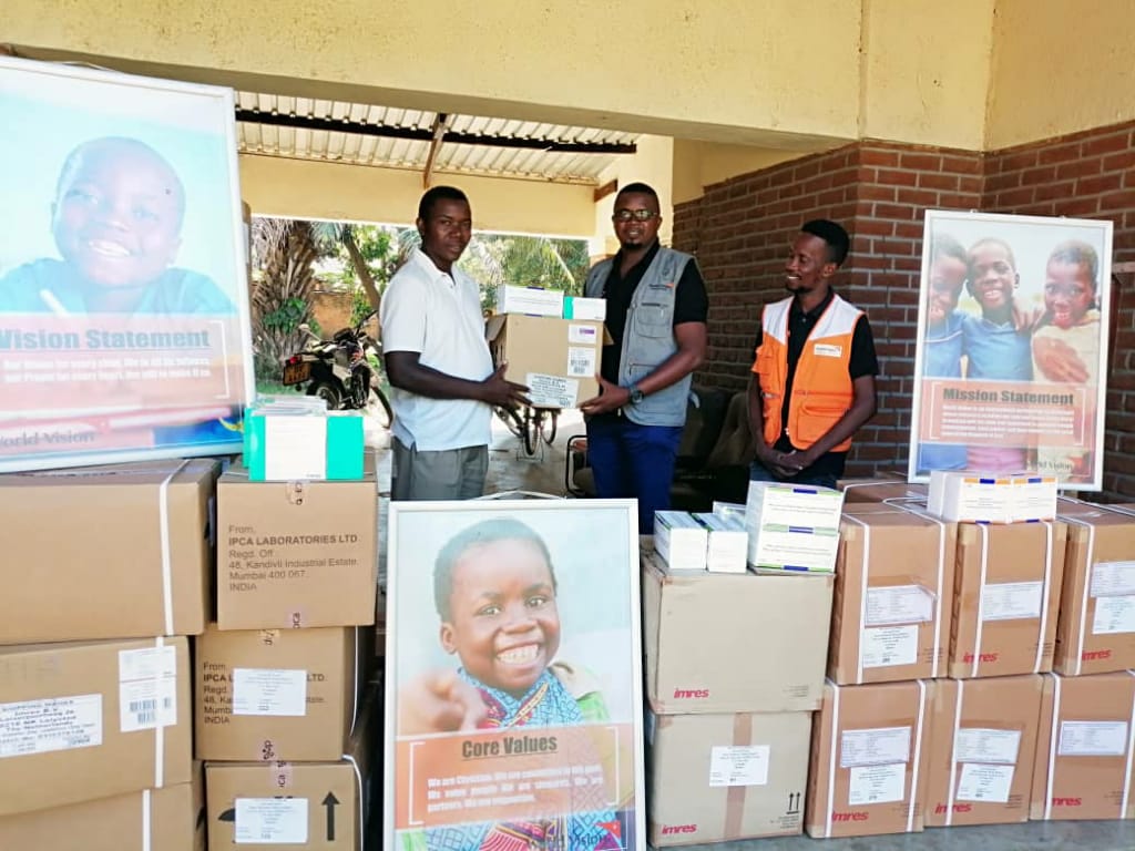 Health Desk Officer Vincent Shaba (in white golf shirt) receiving drugs on behalf of the Diocese