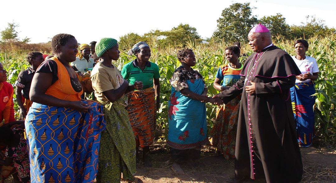 Some of the beneficiaries of Lusubilo's SORT project interacting with Bishop Mtumbuka of Karonga Diocese