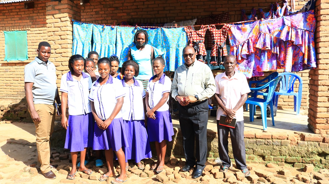 Monsignor Chitete with Tailoring Students at their Pavilion