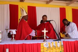 Bishop Mtumbuka Hands Over a Certificate to One of the Newly Ordained Priests