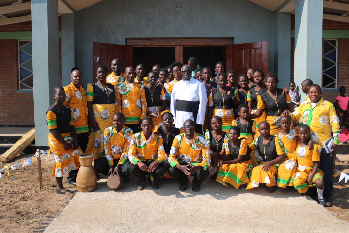 Father Moyo with choir members after Mass