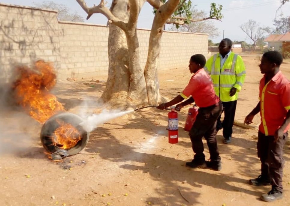 Fuel attendant practicing the use of fire extinguisher