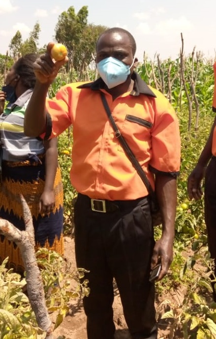 Chairperson for Ibanda Kolping Family Kabaghe showing produce from their garden