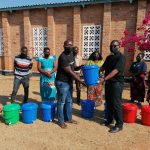 Father-Mwenegamba-R-handing-over-some-of-the-items-to-Catechetical-Methodology-Advisor-Paul-Mwandira