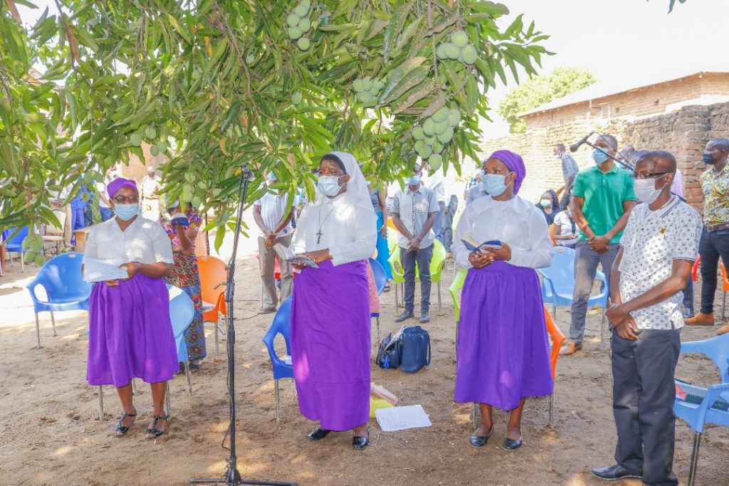 Members of staff singing during the Eucharistic Celebration