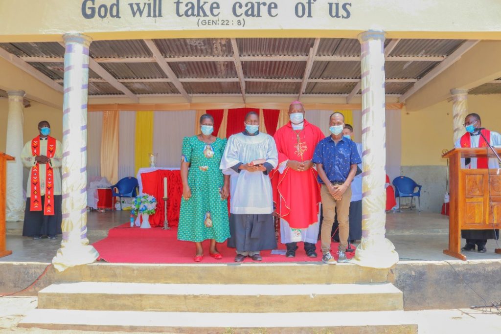 Benedict Nyondo with his wife -Martha (his right), Bishop Mtumbuka (his left) and one of his sons – Pius (his far left)