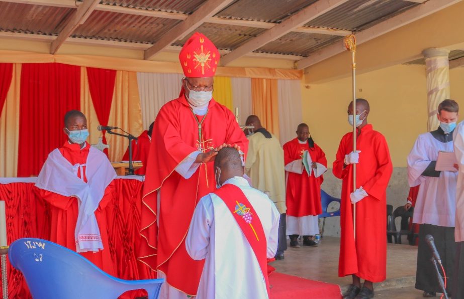 Bishop Mtumbuka laying hands on Deacon Erick Nyondo as part of the ordination rite