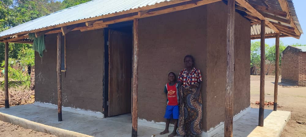 New lease of life: Estida Msonda standing on her newly built house. 