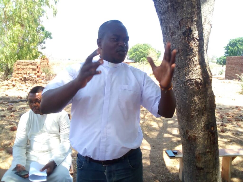 Father Robert Songa speaking during the function